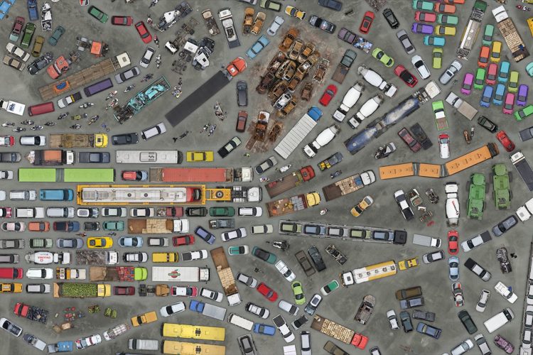 hundreds of cars, trucks, buses and other vehicles from above