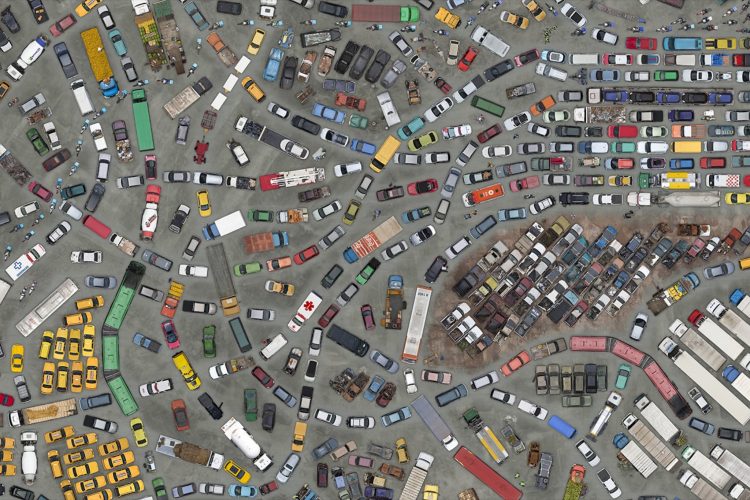 dozes of cars, trucks, buses and other vehicles from above